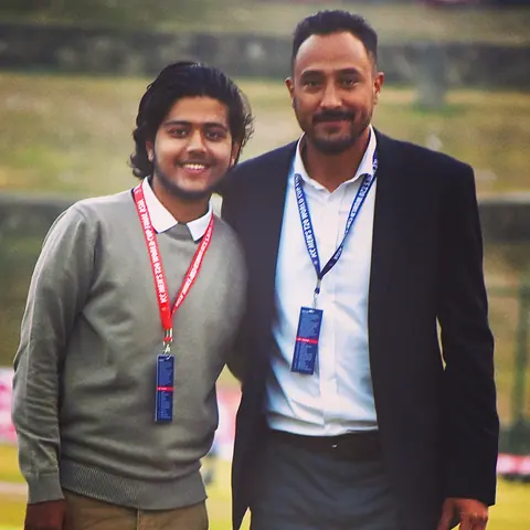Wakif Wagle standing with a colleague at a sporting event.