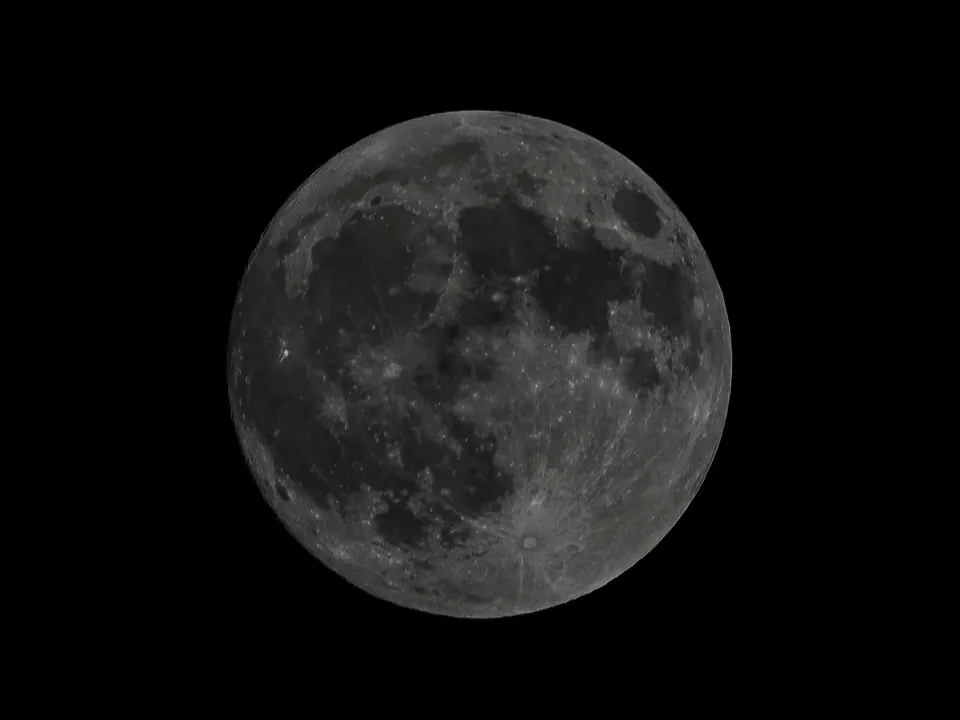 A detailed full moon against a black sky.