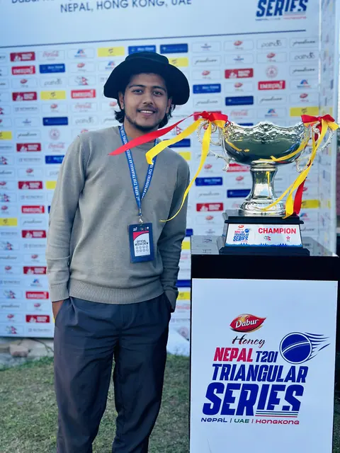 Wakif Wagle beside a Nepal T20 trophy display.