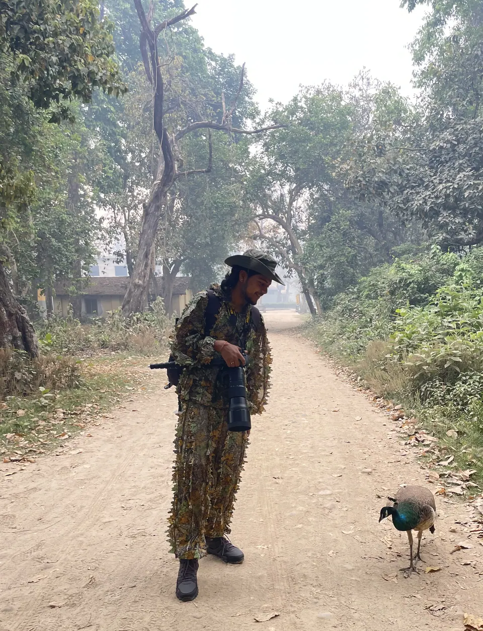 A guide walking a forest path with a dog.