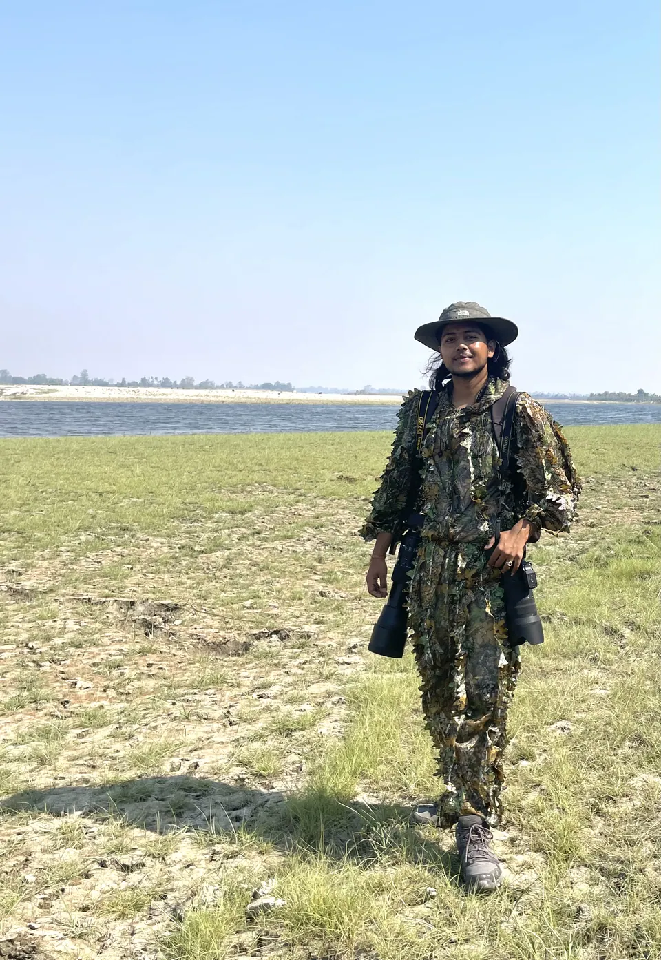 A field guide crossing an open wetland.