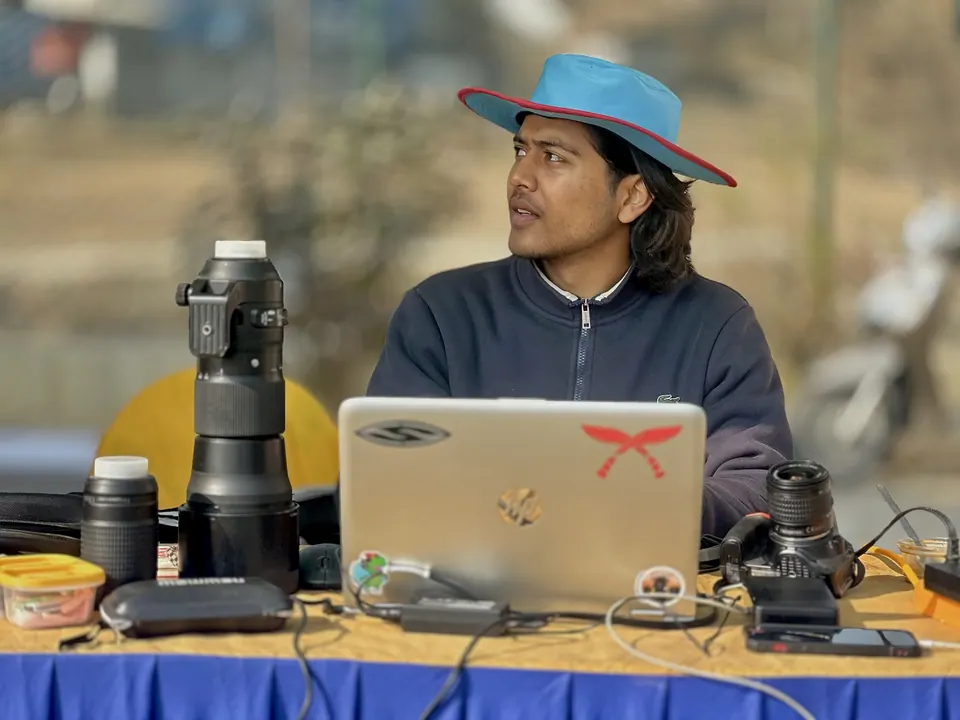 Wakif Wagle with camera equipment and a laptop outdoors.