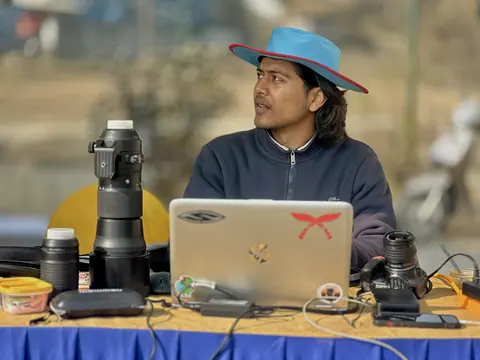 Wakif Wagle with camera equipment and a laptop outdoors.