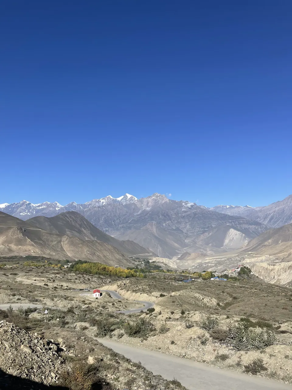 Layered mountain ranges beneath an open blue sky.
