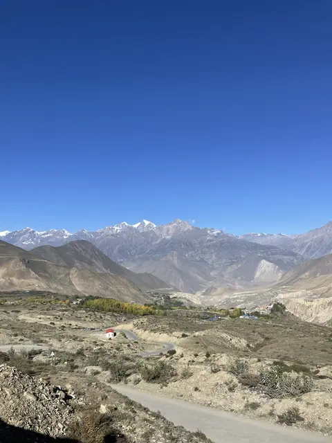 Layered mountain ranges beneath an open blue sky.