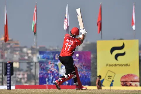 A batter lifting the bat after a stroke.
