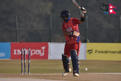 A Nepal batter photographed mid-stroke.